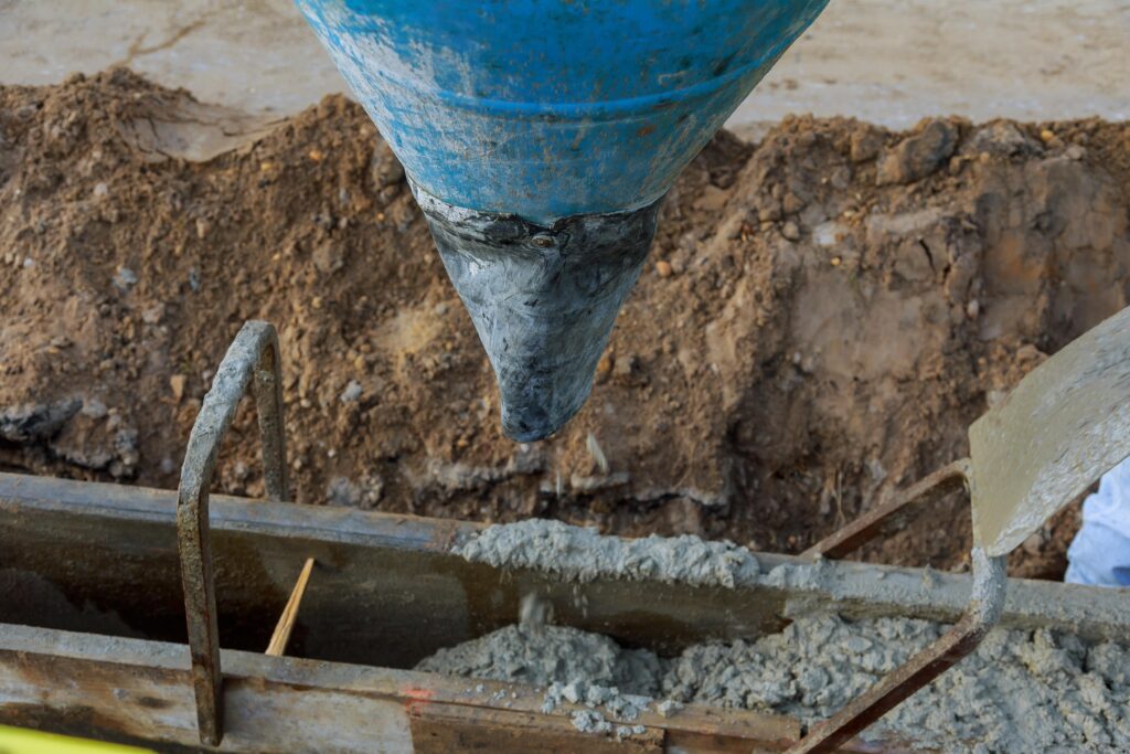pouring cement into a wooden frame