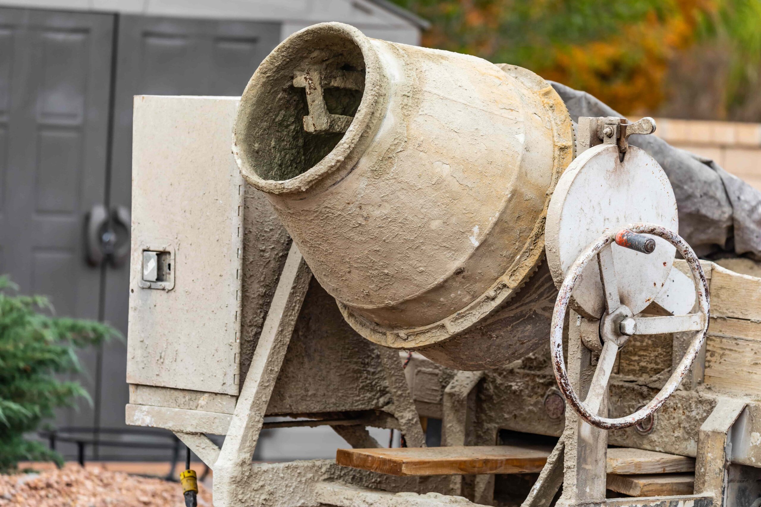concrete mixer covered in cement at a construction site