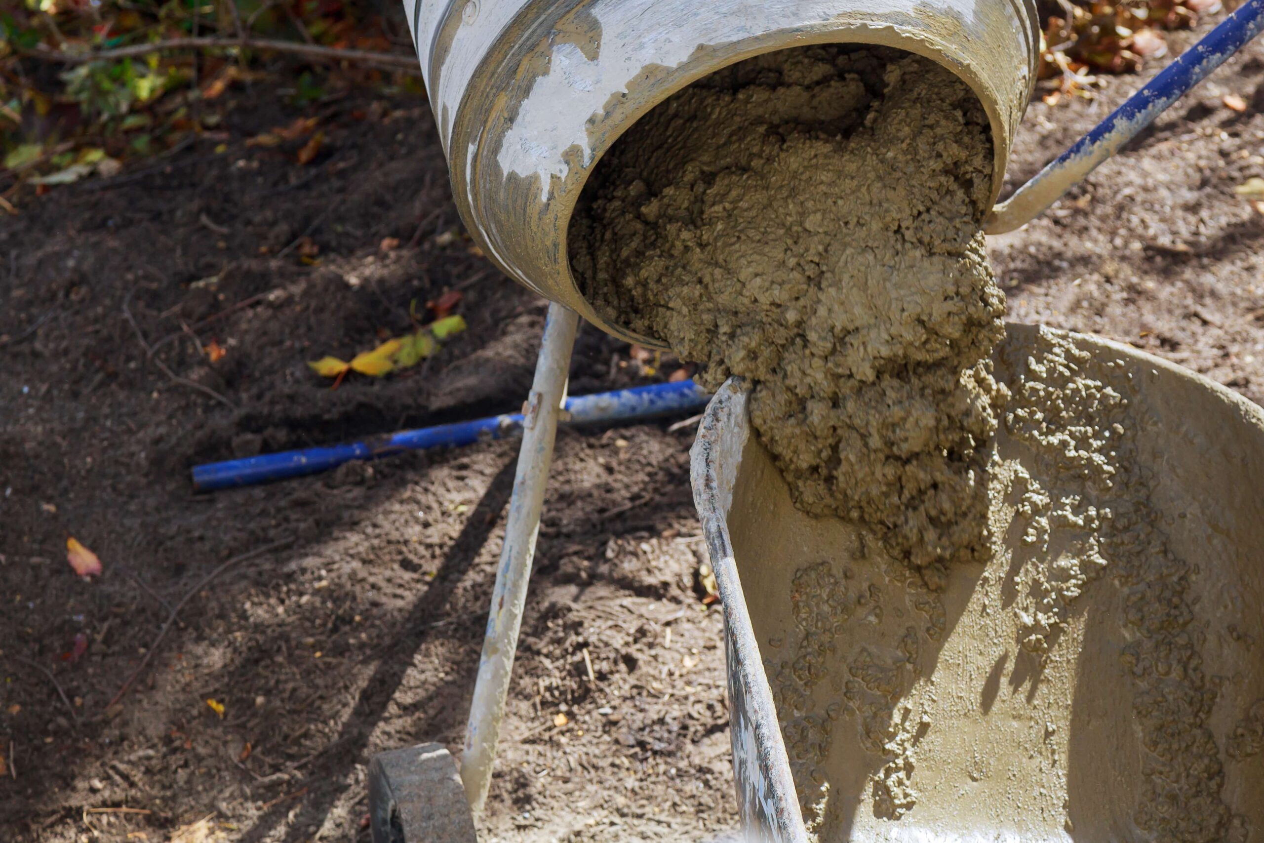 cement mixer filling a barrow on construction site