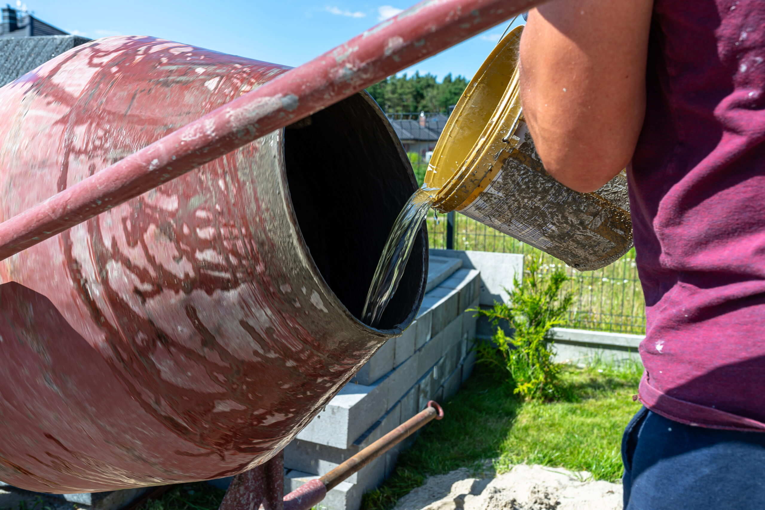 water pouring into cement mixer